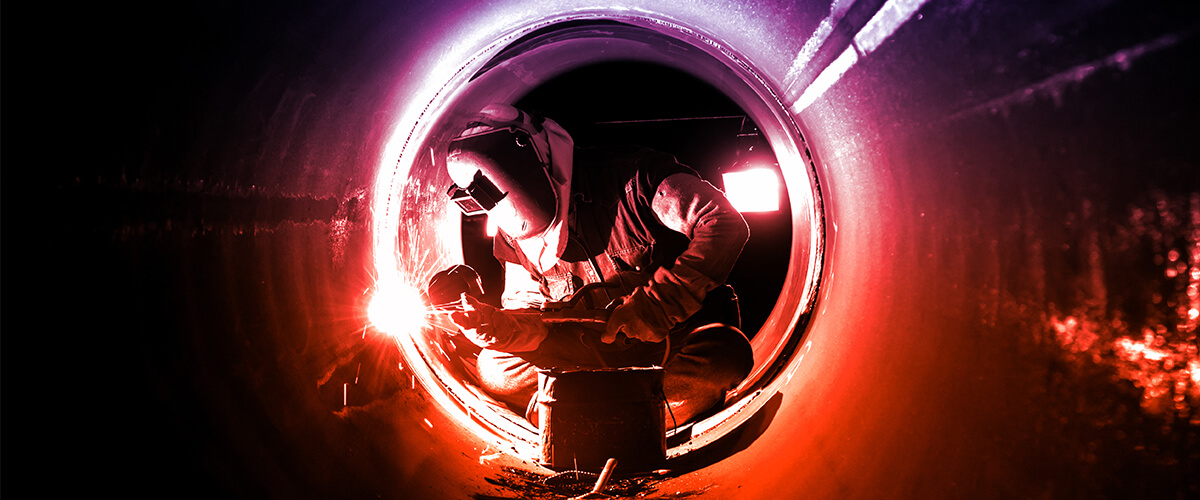 marine engineer pipefitting and welding inside a pipe